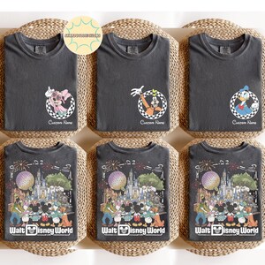 May include: Six dark grey t-shirts with Disney character designs. The top row features Minnie Mouse, Goofy, and Donald Duck in checkered circles with "Custom Name" text. The bottom row displays a Walt Disney World graphic.