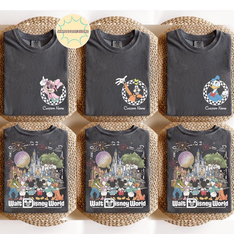 May include: Six dark grey t-shirts with Disney character designs. The top row features Minnie Mouse, Goofy, and Donald Duck in checkered circles with "Custom Name" text. The bottom row displays a Walt Disney World graphic.
