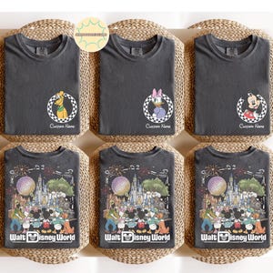 May include: Six dark grey t-shirts with round graphics featuring cartoon characters. The top row includes Pluto, Daisy Duck, and Mickey Mouse. The bottom row features a Walt Disney World design. Each shirt has the text "Custom Name" or "Walt Disney World".