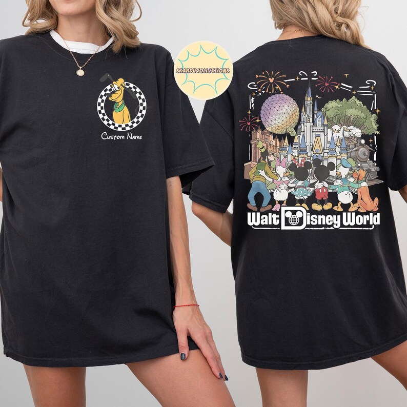 May include: Black t-shirt with a Pluto graphic in a chequered circle on the front. The back shows a colourful graphic of Disney characters and the text "Walt Disney World". The shirt has a crew neck and short sleeves.