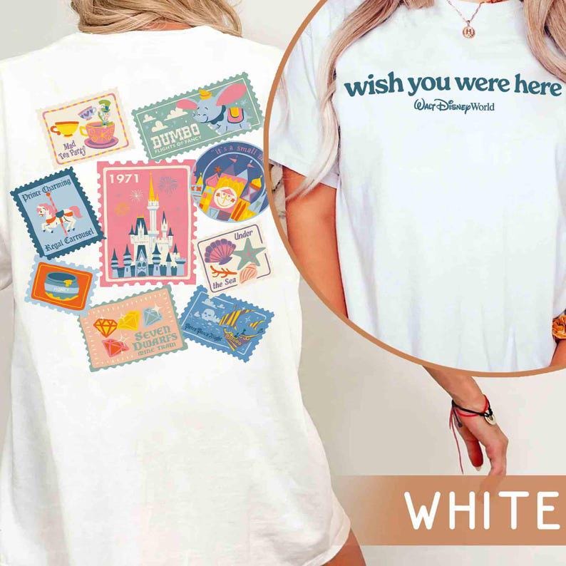 May include: White t-shirt with a design featuring various colorful postage stamp-style graphics. The stamps depict scenes from a theme park, including a castle, Dumbo, and the text "wish you were here" with "Walt Disney World".