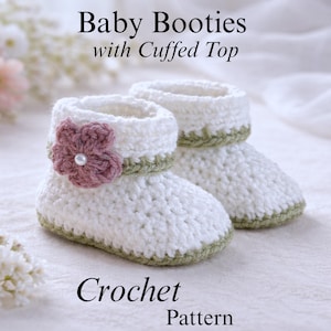 May include: Two white crochet baby booties with a cuffed top, adorned with a pink flower and pearl. The booties have a green trim. The image shows the text "Baby Booties with Cuffed Top" and "Crochet Pattern". The booties are displayed on a white surface.