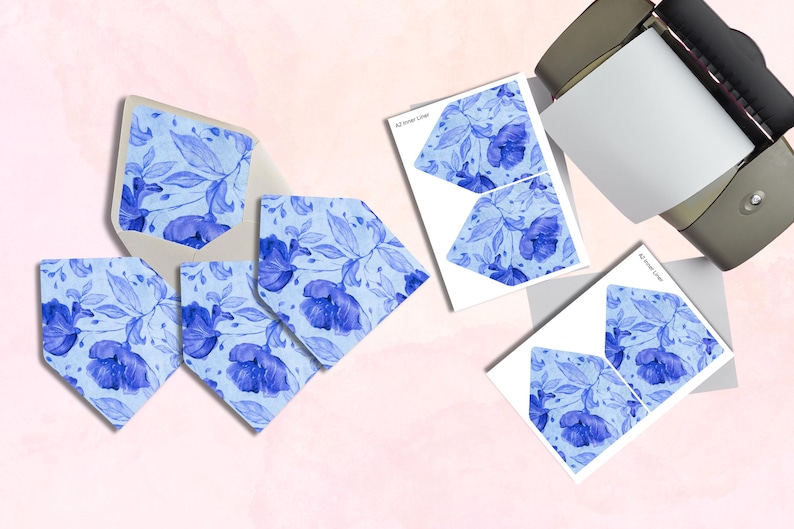 May include: Stationery set featuring blue floral designs. Includes envelopes, cards, and printed inserts. The cards and inserts have a watercolor floral pattern. The envelopes are light blue. The text "A2 Inner Liner" is visible on the inserts.