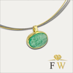 May include: A gold pendant necklace featuring an oval, light green gemstone. The pendant is set in a gold bezel and hangs from a multi-strand silver-tone chain. The necklace is displayed against a neutral background.
