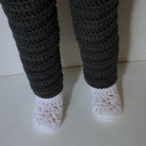 May include: A pair of gray crocheted leggings with white crocheted socks.