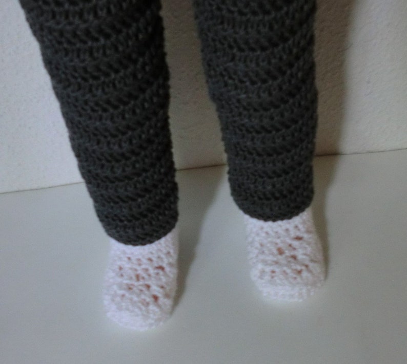 May include: A pair of gray crocheted leggings with white crocheted socks.