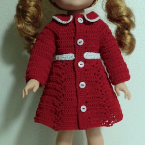 May include: A red crocheted dress with white trim and buttons. The dress is worn by a doll with red hair and pigtails.