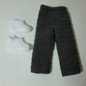 May include: A pair of gray crocheted pants and two white crocheted booties.