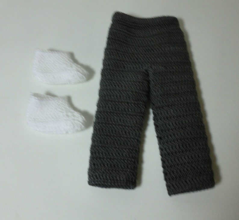 May include: A pair of gray crocheted pants and two white crocheted booties.
