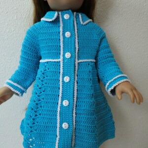 May include: A blue crocheted dress with white trim and buttons. The dress has a fitted bodice and a flared skirt.