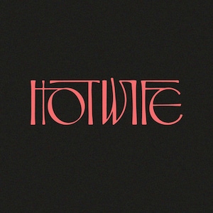 May include: The word "HOTWIFE" in a coral-colored, stylized font is centered on a black background. The letters have a unique, elongated design, with the "O" being a perfect circle.
