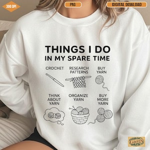 May include: White sweatshirt with the text "THINGS I DO IN MY SPARE TIME" and illustrations of crochet, yarn, and related activities. The design includes the words "CROCHET", "RESEARCH PATTERNS", "BUY YARN", "THINK ABOUT YARN", "ORGANIZE YARN", and "BUY MORE YARN".