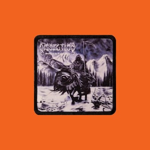 May include: A white ceramic mug with a black handle and the text "But First, Coffee" in a bold, black font. The mug is set against a neutral background, highlighting its simple design.