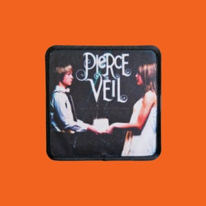 May include: A black square patch featuring the band name "Pierce the Veil" in white script. The image on the patch depicts two people holding hands. The background is dark.