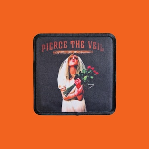 May include: A square patch with the text "PIERCE THE VEIL" in red. The image shows a person in a white dress and veil holding red roses. The background is dark grey, and the patch has a black border.
