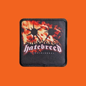 May include: Square black patch featuring the band name "hatebreed" in white gothic lettering over a fiery background. Two black starburst shapes are above the band name. The word "PERSEVERANCE" is below the band name.