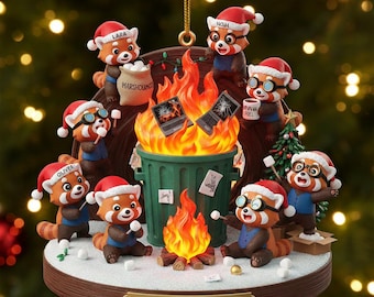 May include: A Christmas ornament featuring red pandas in Santa hats around a dumpster fire. The ornament includes a small Christmas tree, marshmallows, and the text "Dumpster Fire Response Team."
