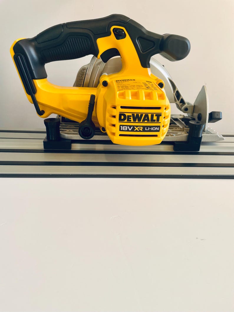 May include: A yellow and black DeWalt 18V XR Li-Ion circular saw. The saw features a black handle and a silver blade. The saw is designed for cutting wood and other materials.