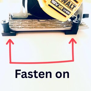 May include: A yellow and black DeWalt 18V XR Li-Ion circular saw. The saw is on a silver base with black supports. The text "Fasten on" is below the saw.