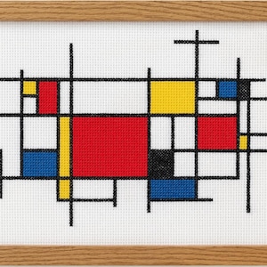 May include: Cross-stitch artwork in a wooden frame. The design features a geometric pattern with red, yellow, blue, and black blocks and lines on a white background. The artwork is framed in a light brown wooden frame.