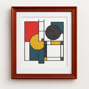 May include: A framed cross-stitch artwork featuring an abstract geometric design. The design incorporates a red rectangle, a yellow semi-circle, a black circle, and blue and white rectangular shapes, all outlined in black. The frame is a dark brown color.