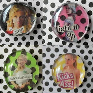 May include: Four round, clear glass-covered buttons with images of a blonde woman and text. The buttons have a black and white polka dot background. The text on the buttons reads: "a fairy?", "light it up", "I ain't that blonde!", and "Kicks Ass!"