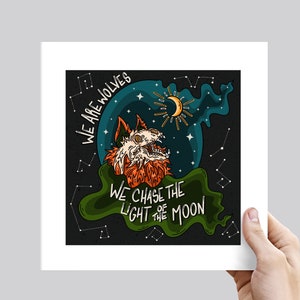 May include: A black and green illustration of a wolf howling at the moon. The wolf is surrounded by stars and the text "We are wolves. We chase the light of the moon."