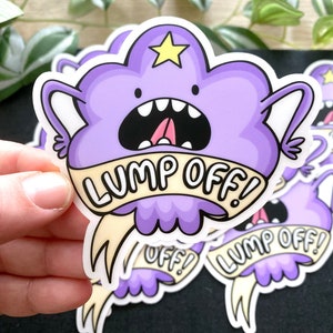 May include: Purple cartoon character with a star on its head and a banner that says "Lump Off!" The character has a wide open mouth and a tongue sticking out. The sticker is white with a purple outline.