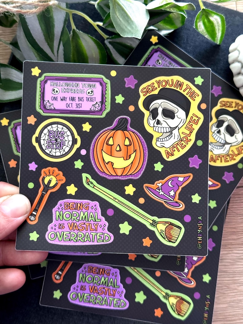 Peut inclure: Autocollants carr&eacute;s noirs avec des illustrations sur le th&egrave;me d'Halloween. Les motifs incluent une citrouille, un cr&acirc;ne, un chapeau de sorci&egrave;re, un balai et les textes "See You in the Afterlife!" et "Being Normal is Vastly Overrated."