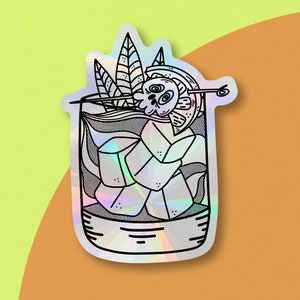 May include: A black and white line drawing of a cocktail with a skull and crossbones design. The cocktail is in a glass with ice cubes and a lime wedge. The image is on a holographic sticker.