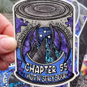 May include: A sticker of a can of soup with a blue, purple, and black galaxy design. The can has the words 'Night Court Canning Co.' and 'Chapter 55 Hot N' Spicy Soup' printed on it.