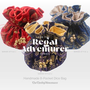 May include: Three handmade dice bags in red, blue, and purple velvet with gold floral patterns. Each bag has a drawstring closure and beaded tassels. Text on the bags reads "For the Regal Adventurer Series" and "Handmade 8-Pocket Dice Bag."