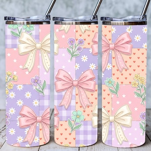 May include: Three stainless steel tumblers with lids and straws. Each tumbler features a pastel patchwork design with bows, flowers, and hearts. The color palette includes pink, purple, peach, and white, creating a whimsical and feminine aesthetic.