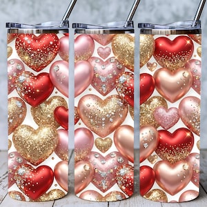 May include: Three stainless steel tumblers with a heart design. The hearts are in shades of red, pink, and gold, some with glitter and rhinestone accents. The tumblers have a silver straw and lid.