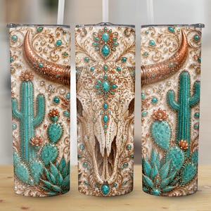 May include: A cylindrical tumbler featuring a detailed print of a bull skull adorned with turquoise gemstones and intricate gold filigree patterns, accompanied by vibrant green cacti and succulents against a cream-coloured background.