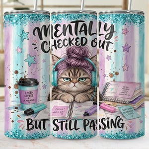 May include: A tumbler with a whimsical design. It features a cat wearing headphones and a purple hair bun, with the text "Mentally Checked Out But Still Passing." The tumbler has a pastel color scheme with stars and coffee cup graphics.