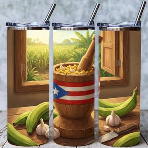 May include: A stainless steel tumbler with a vibrant illustration of a wooden mortar and pestle, filled with garlic and spices, and the Puerto Rican flag. Green plantains, garlic cloves, and a knife are also depicted. A window with a scenic view is in the background.
