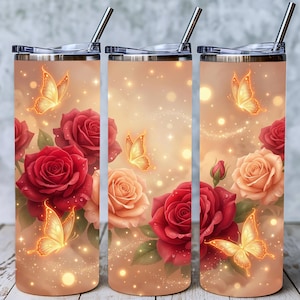 May include: A set of three stainless steel tumblers with lids and straws. Each tumbler features a floral design with red and peach roses, butterflies, and sparkling accents against a light brown background.