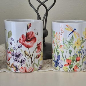 May include: A set of three ceramic mugs with a speckled, matte finish. The mugs are in shades of cream, light gray, and dark gray. Each mug has a simple, minimalist design, perfect for coffee or tea.