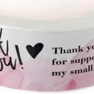 May include: A white ceramic mug with a black handle and the text "But First, Coffee" in a black, bold font. The mug is on a white surface. The mug is likely for hot beverages.