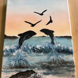 May include: A painting of two dolphins jumping out of the water with a sunset in the background. There are also four birds flying in the sky.