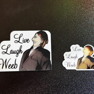 May include: Two stickers with a cartoon image of a person looking up, wearing a suit. The stickers have the words "Live Laugh Weeb" in cursive. One sticker is larger than the other.