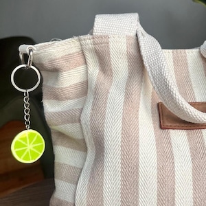 Handmade clay lime slice keychain, unique miniature fruit accessory, cute lime bag charm for keys or backpacks, or a gift for fruit lovers.