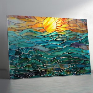 May include: Stained glass artwork depicting a sunset over the ocean. The sun is a bright yellow circle, with orange and yellow hues in the sky. The ocean is a mix of blues and greens, with a wavy pattern.