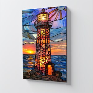 May include: A stained glass artwork depicting a lighthouse at sunset. The lighthouse is constructed of colorful, textured stones, with a bright light emanating from the top. The sky transitions from blue to orange, with the sun setting over the ocean.