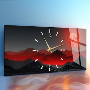 May include: Rectangular wall clock with a landscape design. The clock face has white numbers and gold hands. The background features a red and black mountain range with a red moon.