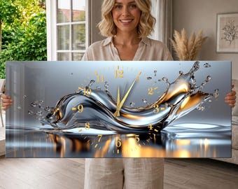 May include: A rectangular wall clock featuring a dynamic liquid splash design in metallic silver and gold tones. The clock face displays gold-colored hour markers and thin gold hands, set against a fluid, abstract background of splashing water.