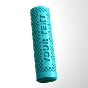 May include: A teal cylinder featuring a diamond pattern and the words "YOUR TEXT" running vertically. The object has a dark teal base and a textured surface. The design is modern and clean.