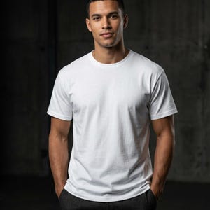 May include: A plain white short-sleeved t-shirt with a crew neckline. The garment features a standard fit, a straight hemline, and a smooth, solid-colored fabric construction. The design is simple, featuring no patterns, graphics, or visible branding.