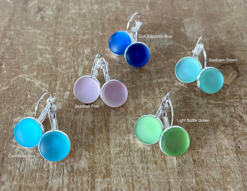 May include: A set of six pairs of earrings with different coloured glass cabochons. The colours are: Caribbean Sea, Seashell Pink, Soft Sapphire Blue, Seafoam Green, Light Bottle Green.